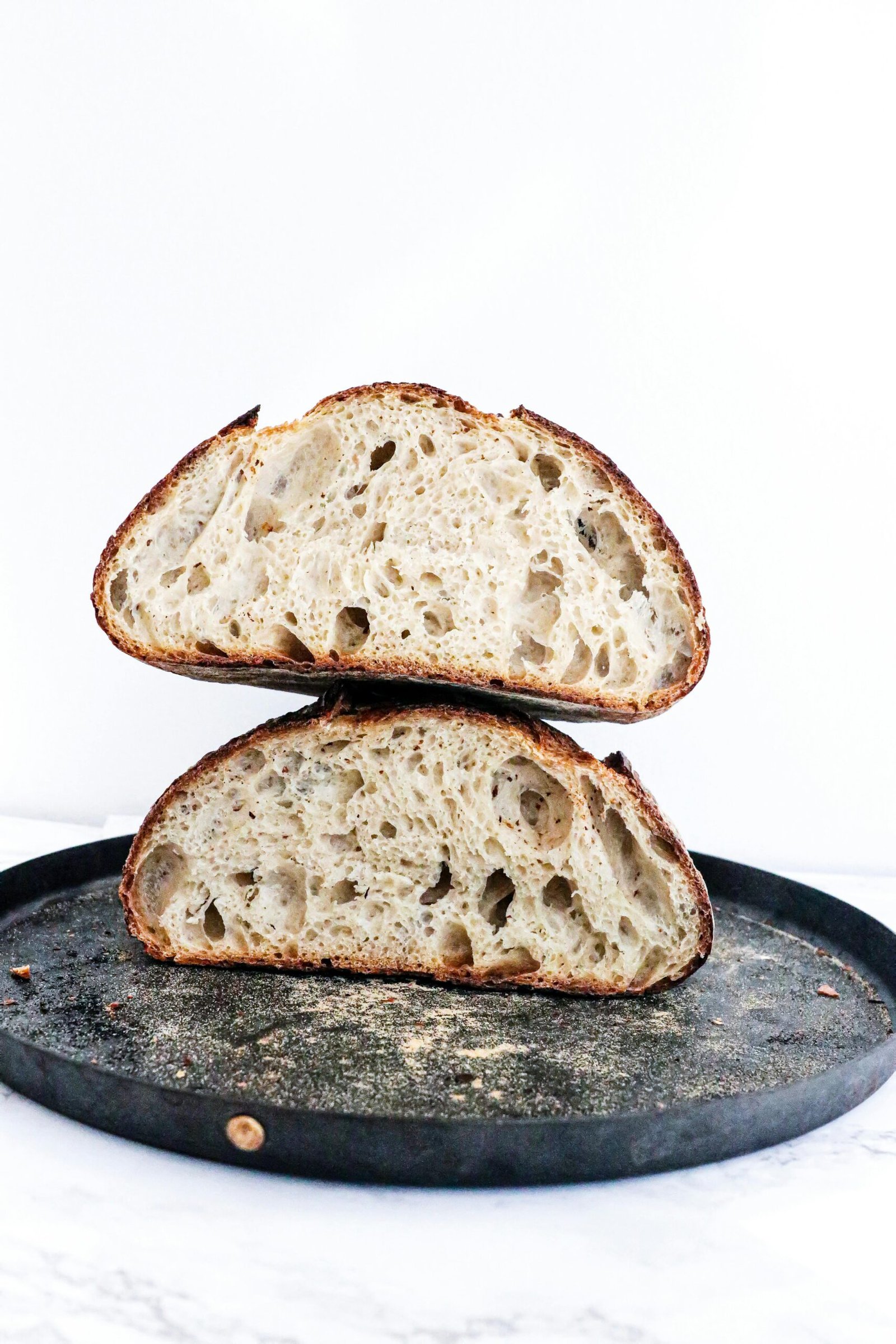 Fresh homemade bread placed on tray on table on white background in light place
